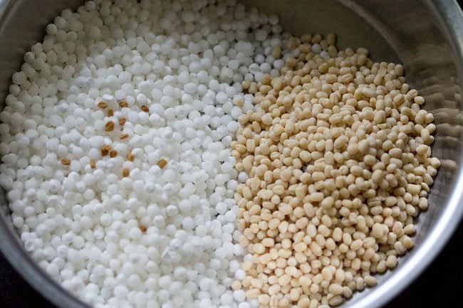 sabudana, urad dal and methi seeds added to a bowl. 