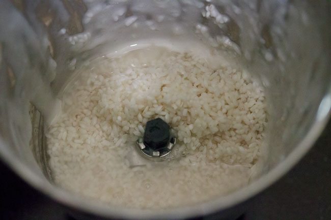 drained idli rice added to the grinder jar along with some fresh water. 