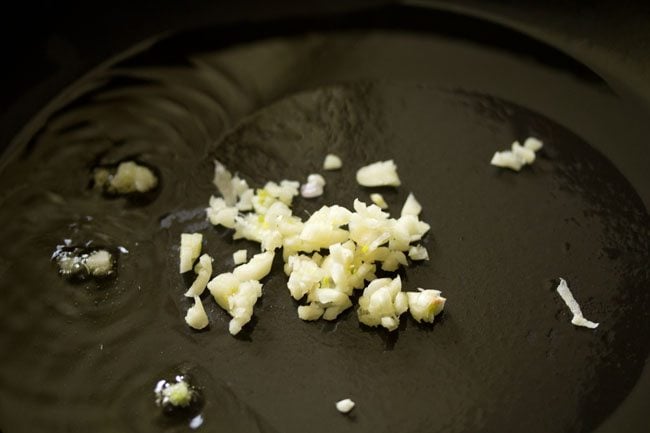 garlic in olive oil in a pan