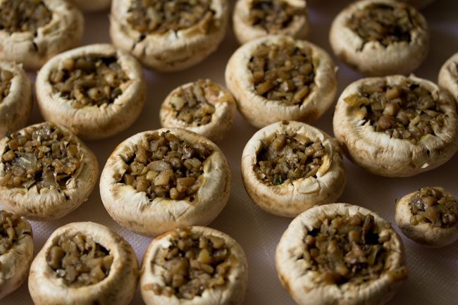 full pan of mushroom stuffing in the mushroom caps.