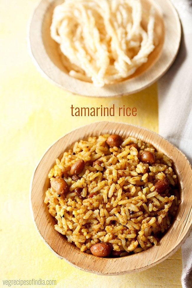 tamarind rice served in a bowl with fried papad and text layovers.