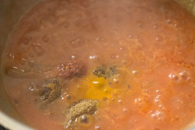 spice powders added to the tomato mixture. 