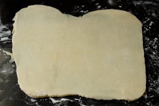 puff pastry is in a rectangle for preparing veg pizza puffs recipe.