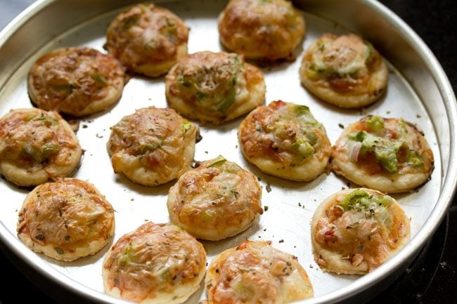 baked veg pizza puffs on baking tray.