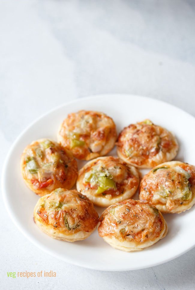 veg pizza puffs on a white plate with a white background.