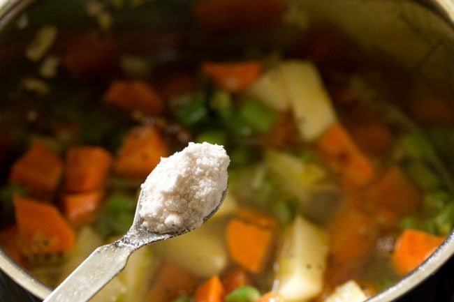 adding salt to the vegetable mixture. 