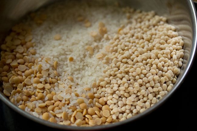 idli rice and lentils in a bowl for making vendhaya dosa. 