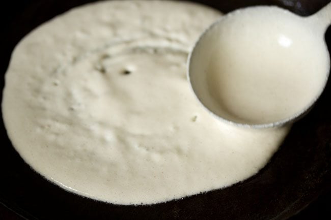 spreading the batter into a round and slightly thick methi dosa. 