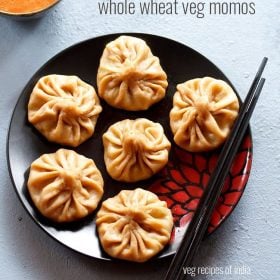 wheat momos arranged on a black plate with black chopsticks kept on the left side with text layovers.