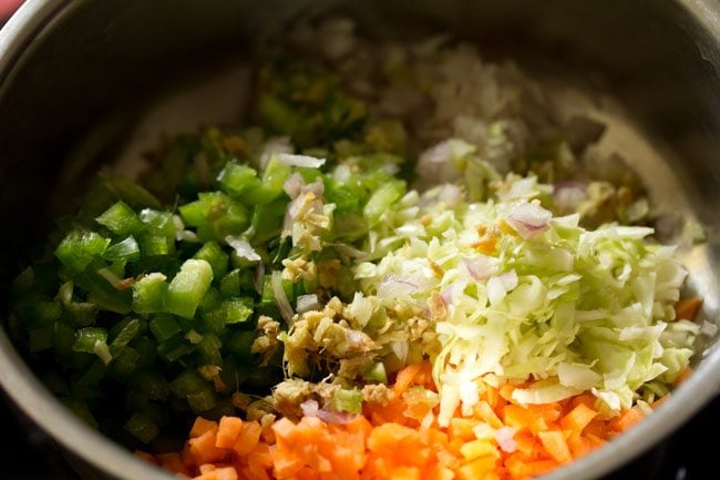 finely chopped ginger added to chopped mixed vegetables in the bowl. 
