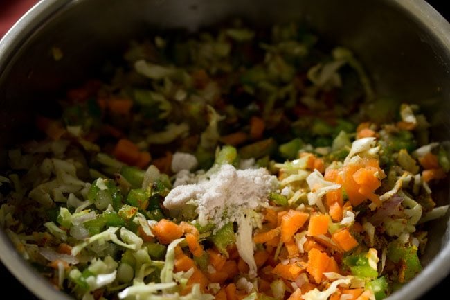 salt added to the vegetable mixture in the bowl. 