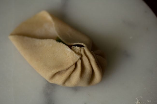 pleating the wheat momos. 