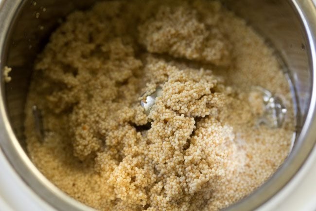 drained poppy seeds added to a grinder jar. 