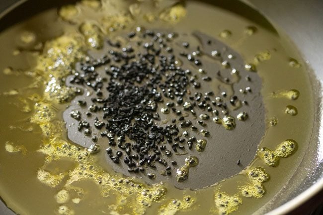 nigella seeds added to the hot mustard oil. 