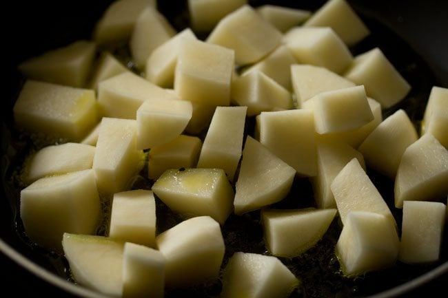 chopped potatoes added to the pan. 
