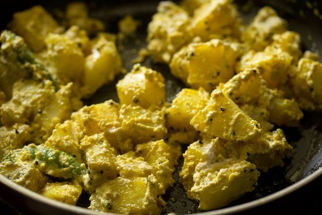 preparing aloo posto recipe