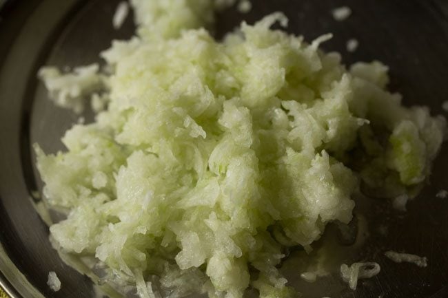 grated ash gourd for making white pumpkin halwa. 