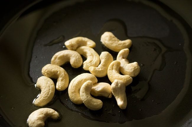sautéing cashews till light golden for making white pumpkin halwa. 