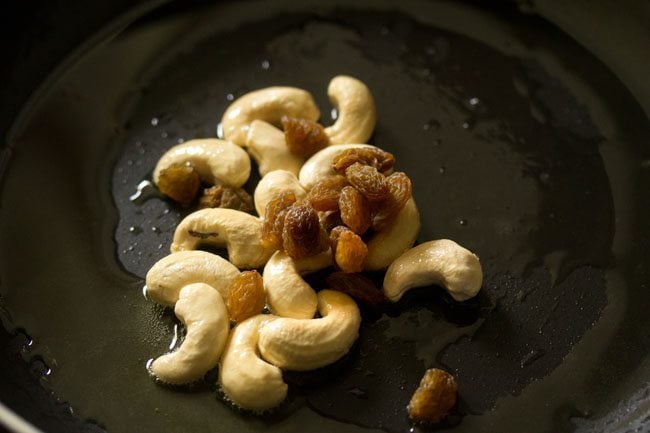 raisins added to cashews for making white pumpkin halwa. 