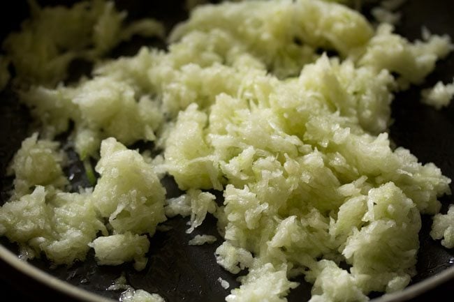 grated ash gourd mixed well in the ghee for making ash gourd halwa. 