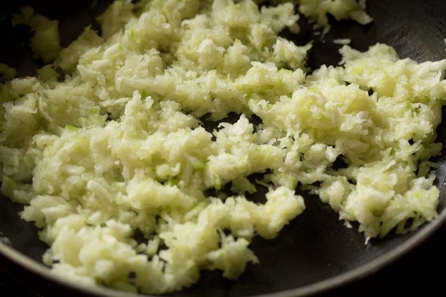 cooking ash gourd for making ash gourd halwa. 