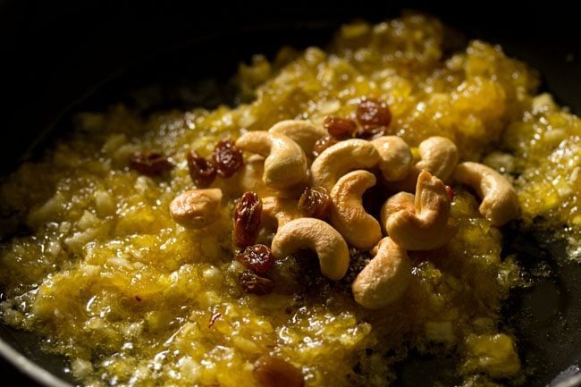 fried cashews and raisins added to the cooked kashi halwa. 