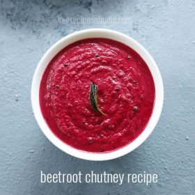 overhead shot of beetroot chutney in white bowl on a light grey blue board with text layovers
