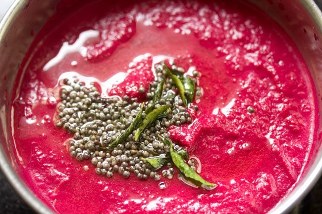 tempering added to beetroot chutney in a bowl