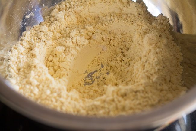 depression made at the center of the gram flour mixture. 