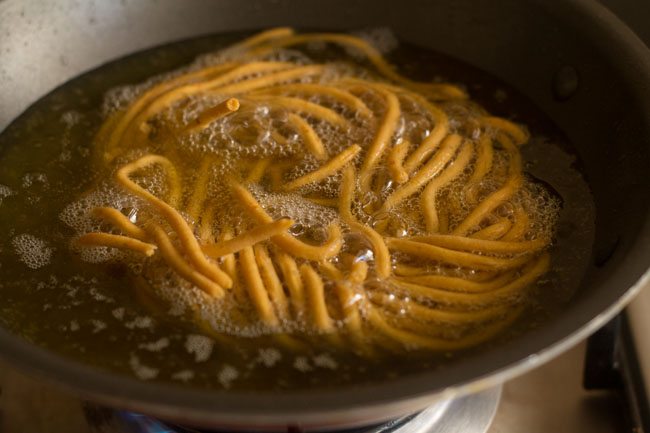 frying besan sev till golden and crisp from all sides.