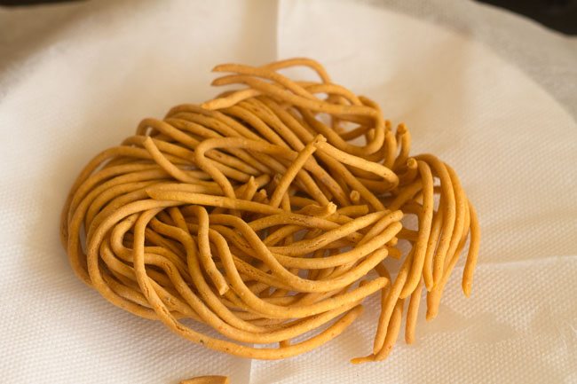 fried sev placed on kitchen paper towel.