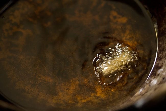 checking the temperature of hot oil to fry butter chakli.