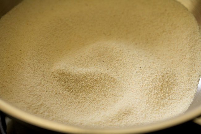 fine rava added to a hot pan for chow chow bath.