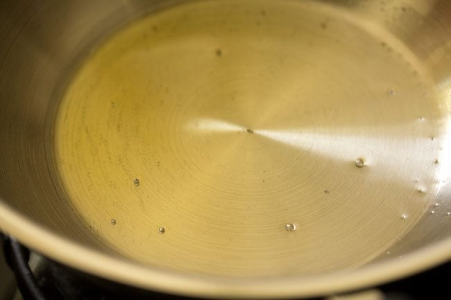 heating ghee or oil in a pan. 