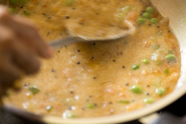 stirring roasted rava in the boiling water. 