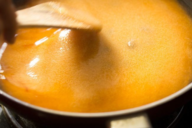 stirring the roasted rava in the sugar solution.