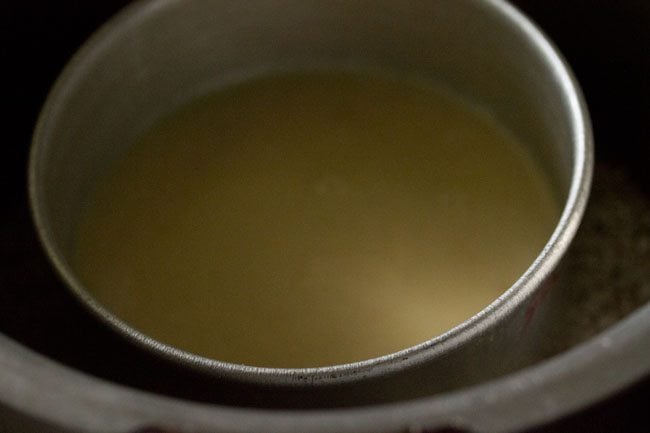 pan with cake batter in cooker