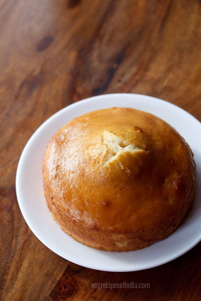 golden round cooker cake on a white plate