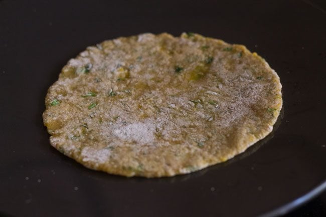 cooking kaddu paratha on tawa