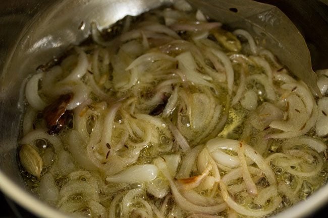 sautéing onions in the pan. 