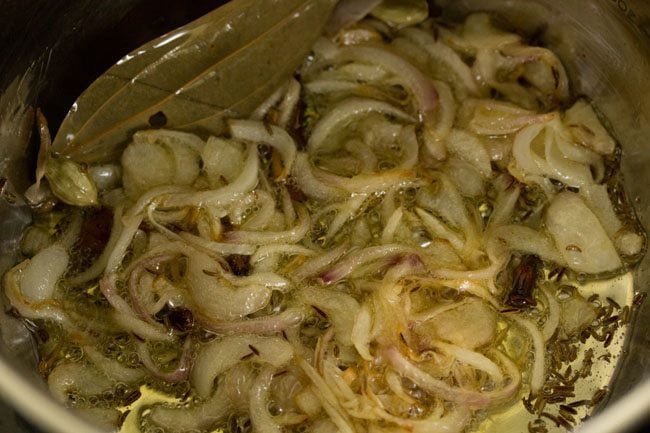 sautéing onions in the pan. 