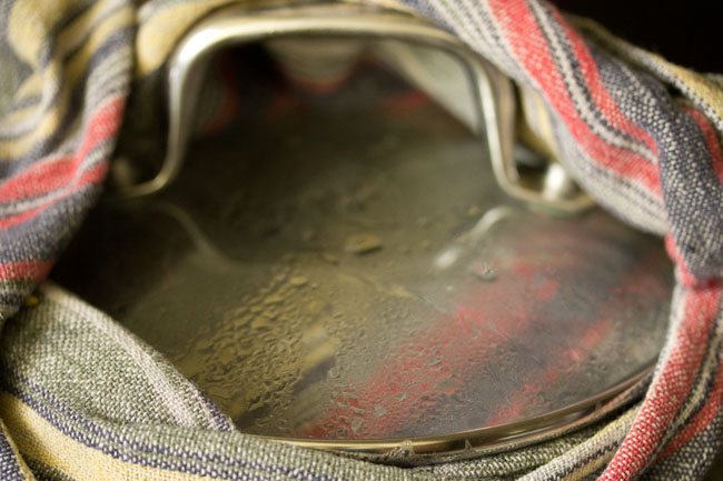 pan covered with a kitchen towel and then closed with a lid. 