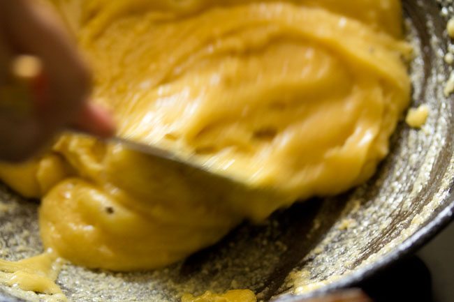 preparing mysore pak while stirring