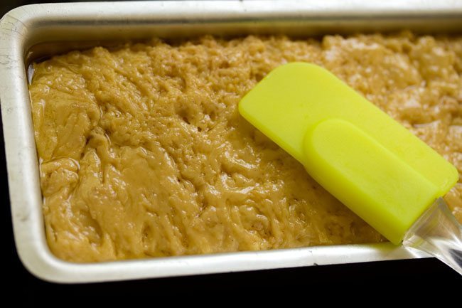 leveling mysore pak with a spatula