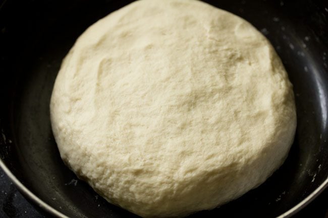 kneaded pizza dough in a bowl kept for resting