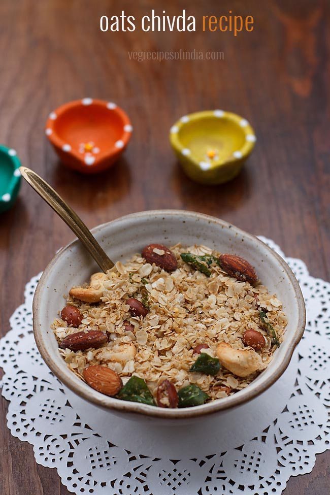 oats chivda served in a ceramic bowl with a spoon in it.