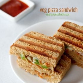 pizza sandwich served in a white place with tomato ketchup