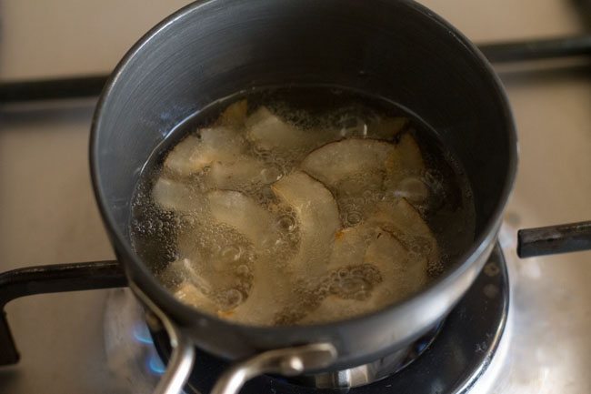 dry coconut slices frying in hot oil