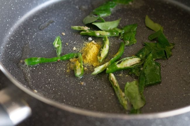 green chillies, curry leaves and asafoetida in oil in pan