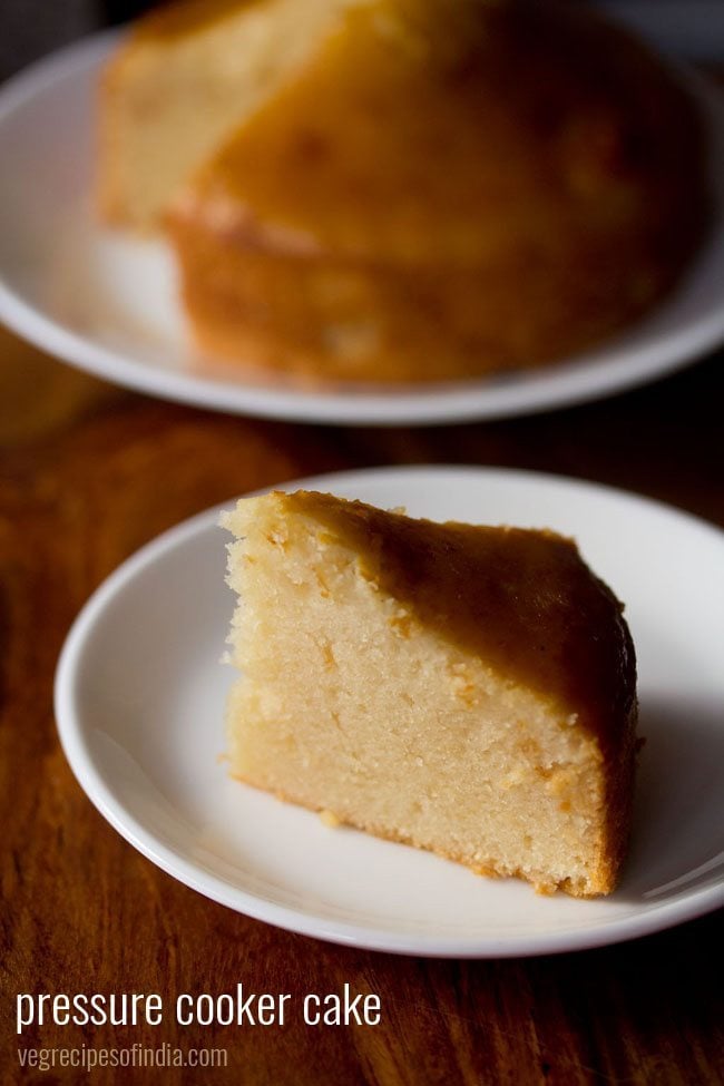 closeup photo of thick triangle slice of pressure cooker cake on white plate with text layovers